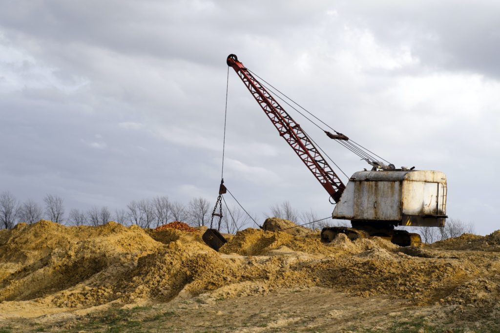 Excavators in the red clay quarry